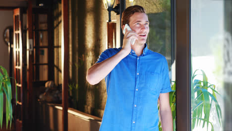 man talking on mobile phone in restaurant