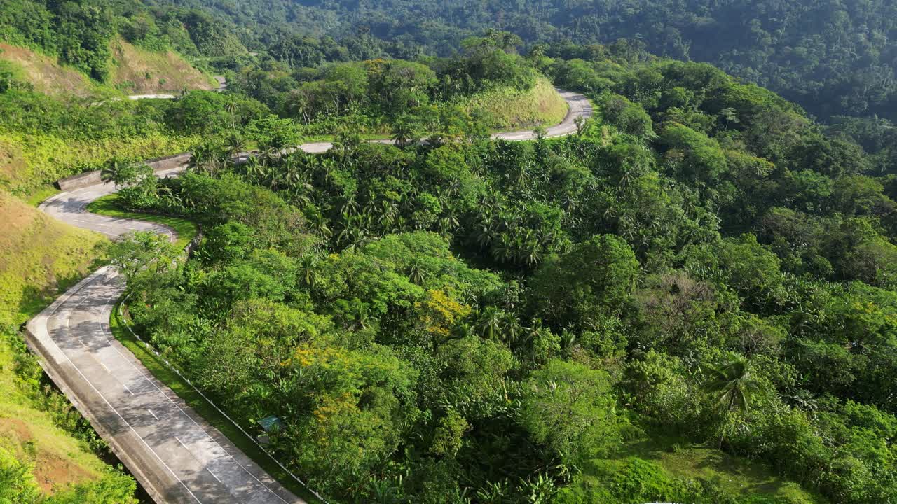 carretera de montaña curva con bosque verde en las colinas en verano
