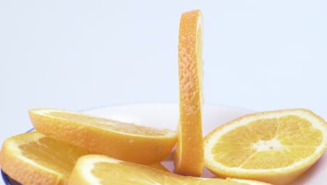 close up fresh valencia orange sliced with white background shallow focus and slowly rotating
