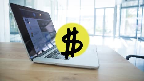 Animation-of-dollar-symbol-over-laptop-on-desk-in-office