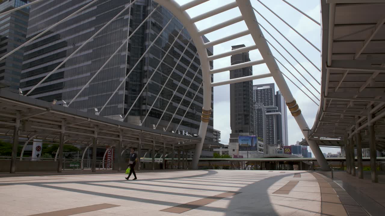 Person Walking On The Empty Sky Bridge In Chong Nonsi, Bangkok, Thailand During COVID-19 Outbreak - Wide Shot