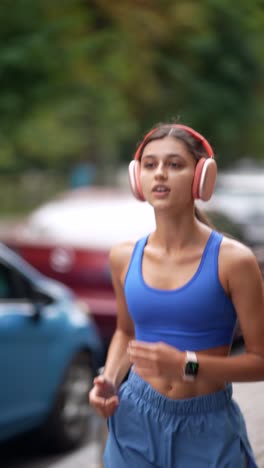 woman running outdoors with headphones