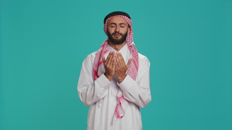 islamic man praying to allah in studio