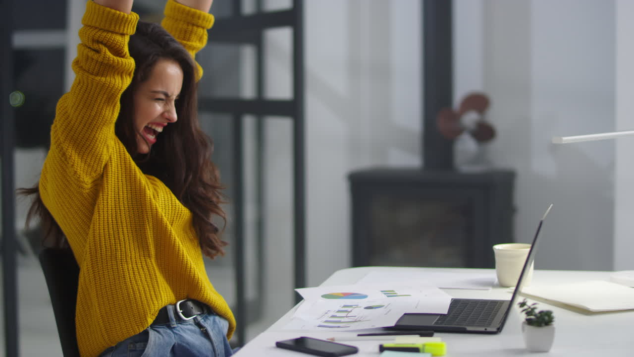 Close-up view of successful woman making winner gestures