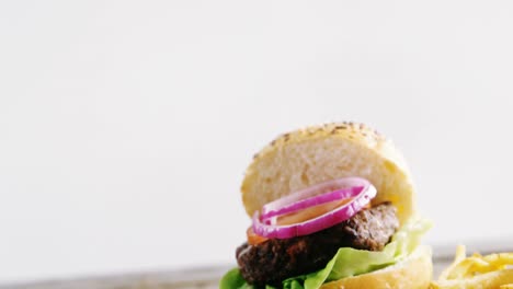 Hamburger-and-french-fries-on-chopping-board