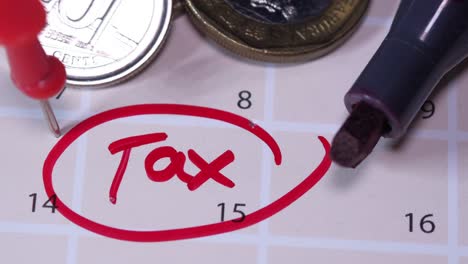 tax reminder on calendar with coins