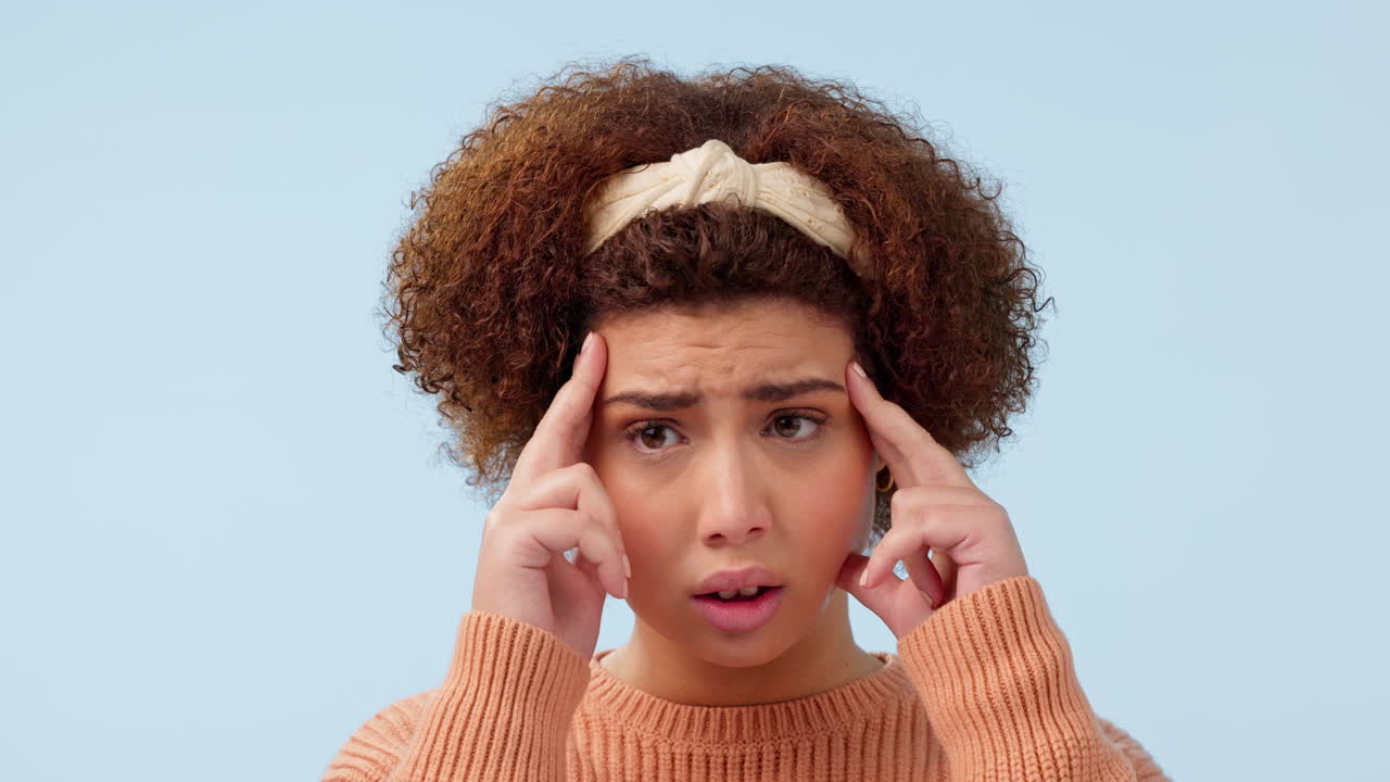 Stress, headache and face of woman in studio