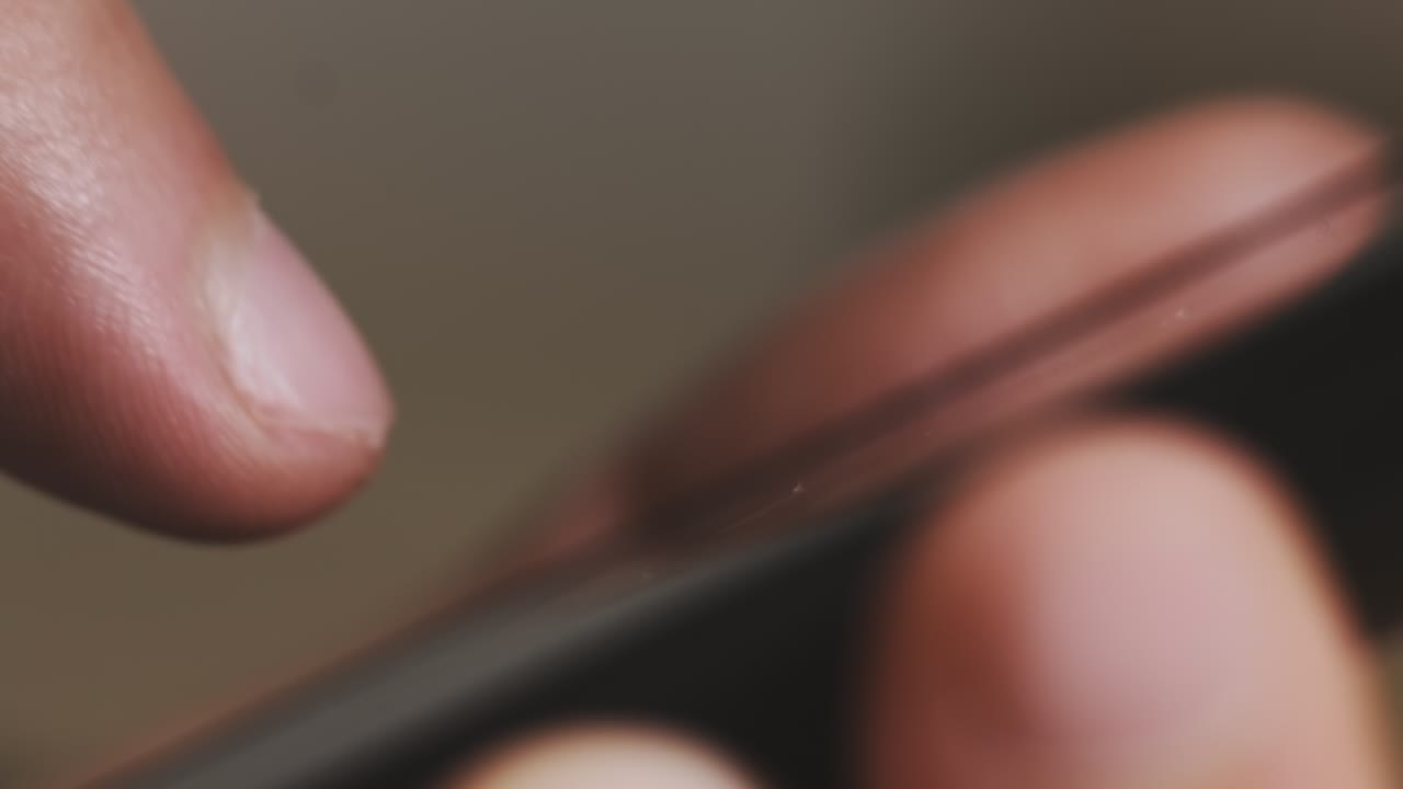 Man uses modern smartphone checking social networks macro