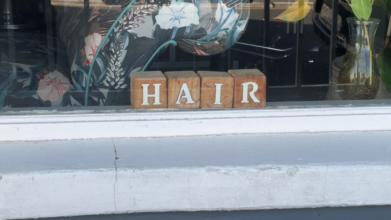 A ‘Hair’ sign written with kiddies blocks to advertise a hairdresser in Cape Town’s southern suburbs.