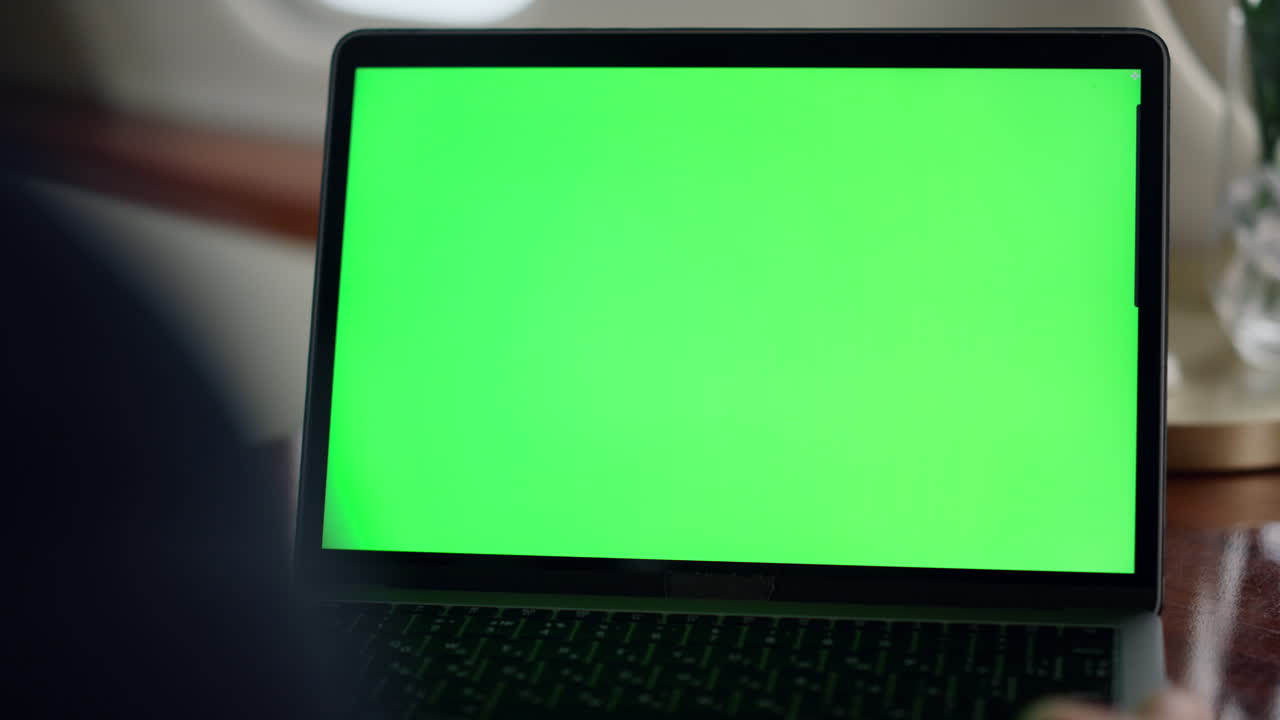 Closeup hand waving green laptop screen. Manager videocalling chroma key partner
