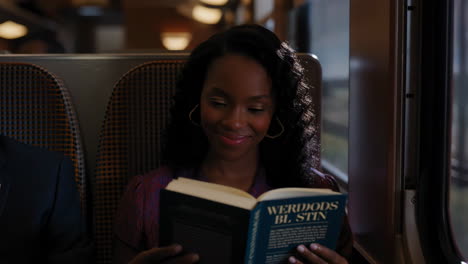 woman reading a book on a train