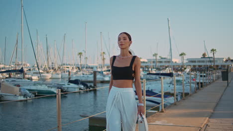 stylish woman walking in a marina