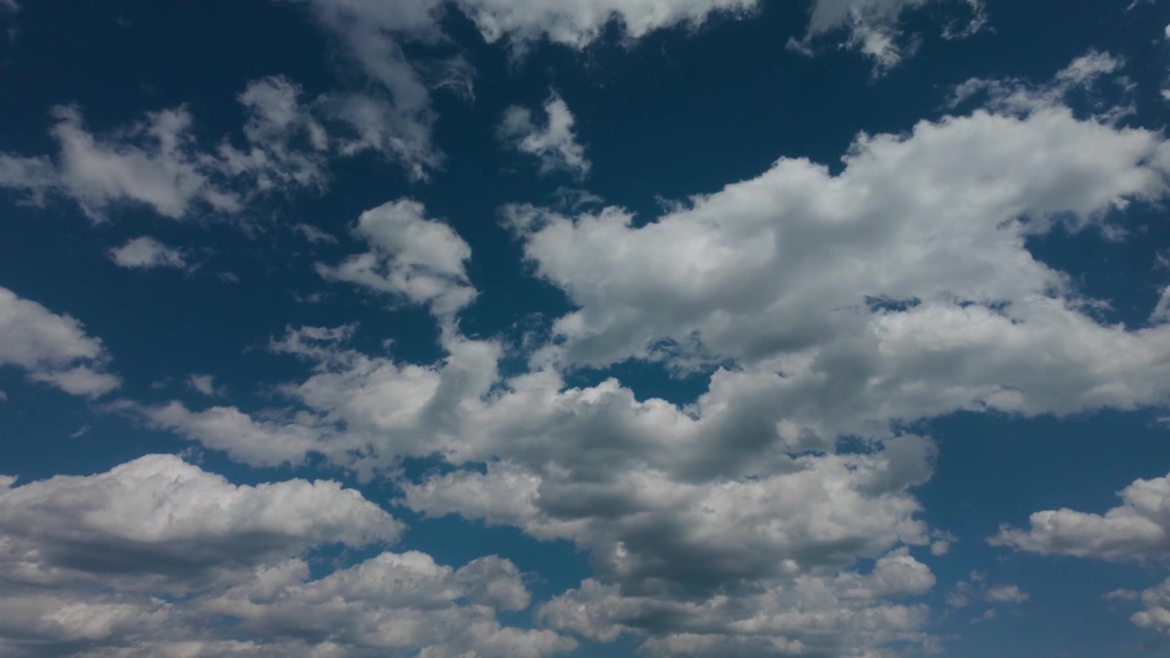 White puffy clouds on a day with a perfect sky.