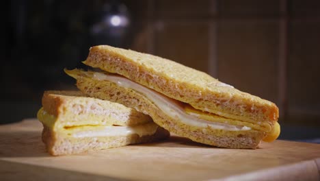 fresh egg and cheese toast ready to eat on wooden board