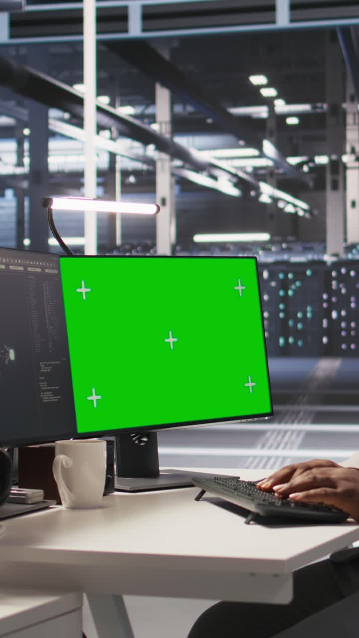 Vertical video Data center admin inspecting gear using green screen mockup PC