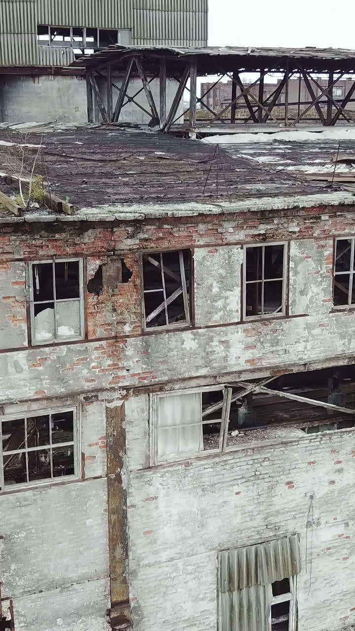 Abandoned ruined industrial factory building, ruins and demolition concept. Aerial view. Vertical video