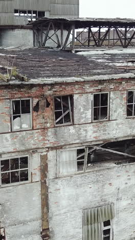 abandoned ruined industrial factory building, ruins and demolition concept. aerial view. vertical video