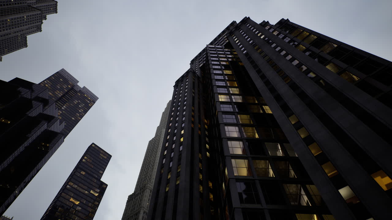Tall city buildings rise against a cloudy sky during twilight hours