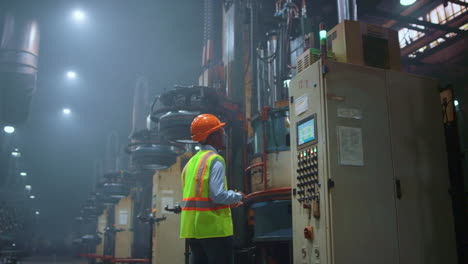 Man-professional-supervisor-analysing-huge-metal-construction-work-at-storage.