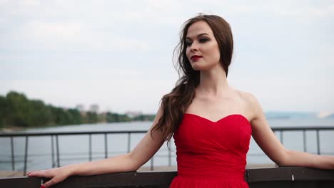woman in red dress by the lake