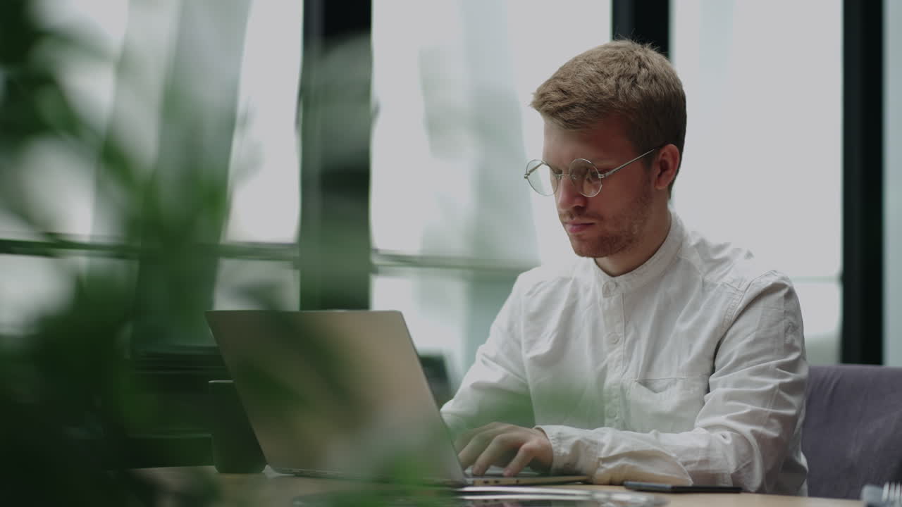 worker of big company is working in office answering on questions of clients in online chat