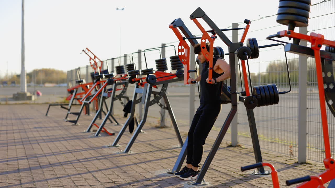 Man working out on outdoor gym equipment