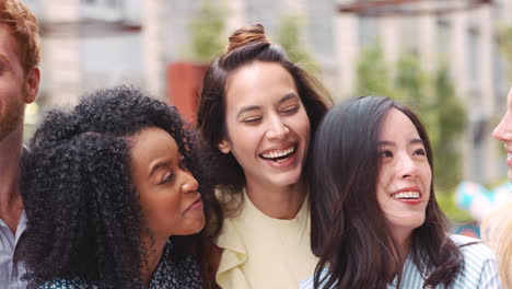 happy young colleagues outside their workplace, close up