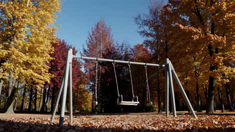empty swing set in autumn park