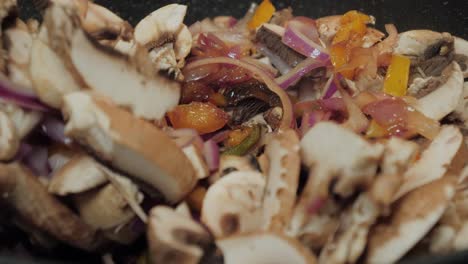 motion controlled slow motion shot of mushrooms in a cooking pan