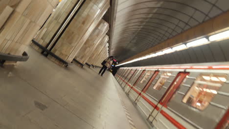 spinning slow motion of metro subway station and train arriving on platform