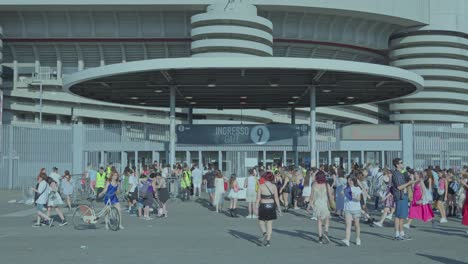 large crowd entering a stadium gate
