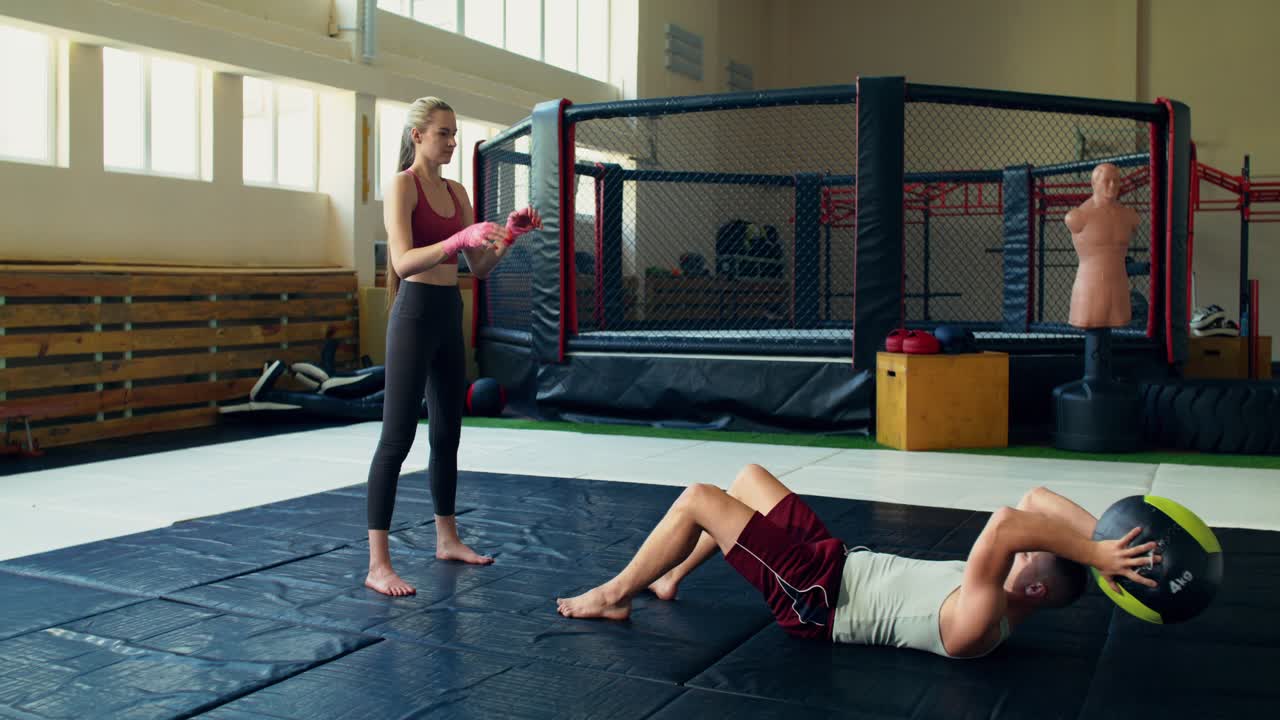 Couple exercising with medicine ball in gym