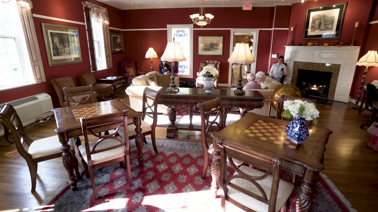 Interior of a Living Room with Chess Tables and Fireplace