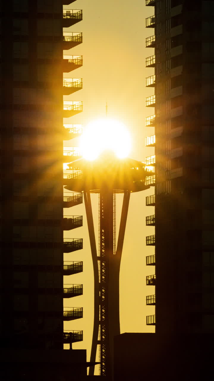 Vertical Timelapse footage of the Space Needle perfectly aligned with the setting sun during a stunning summer sunset.
