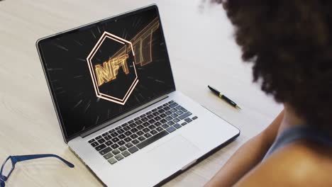 african american businesswoman using laptop for video call with nft text