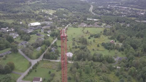 drone aerial rotating view around a radio tower several hundred feet tall in the heart of the green mountains