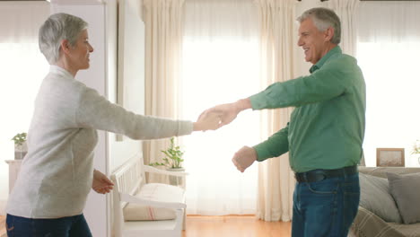 retirement and senior couple dance to music to