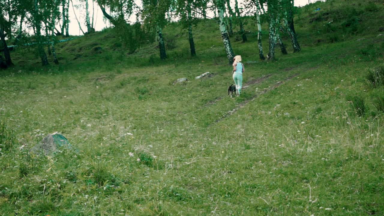 Woman and dog hiking in the forest