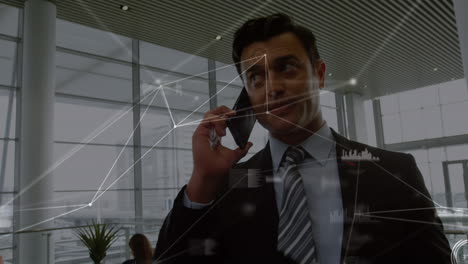animation of network of connections over caucasian businessman talking on smartphone at office