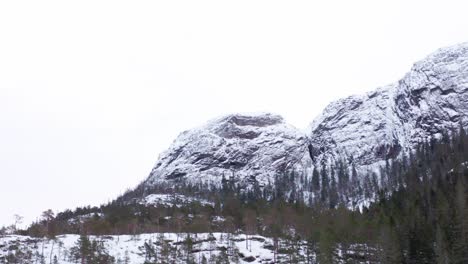 rocky mountain range covered with snow in winter in hildremsvatnet nature preserve in norway