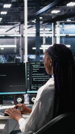 vertical video data center female programmer uses machine learning algorithms to analyze datasets