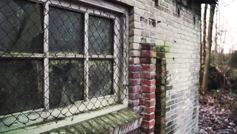 old abandoned brick building with rusty window