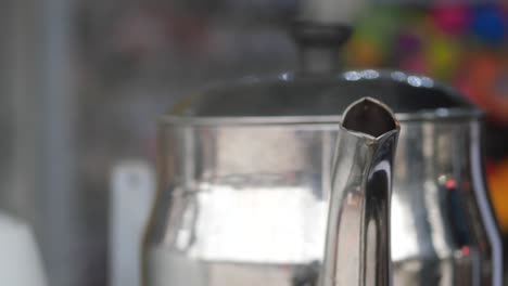 closeup of a silver teapot spout