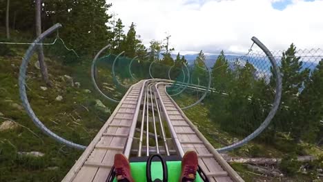 pov of a rider on a sled rollercoaster track on a hillside in andorra in this action adventure footage