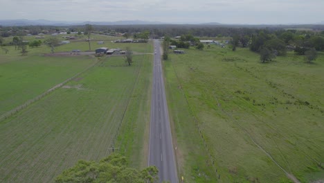 Aerial-View-Of-Long-Asphalt-Road-Through-Rural-Fields-In-New-South-Wales,-Australia