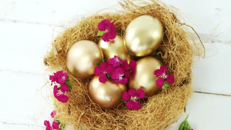 huevos de pascua dorados en el nido