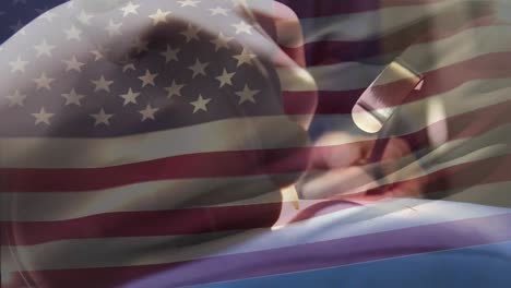 animation of flag of usa waving over surgeons in operating theatre