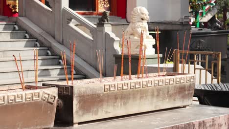 incense sticks burning at a temple entrance