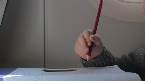 close up view of small boy learning to writing with pencil