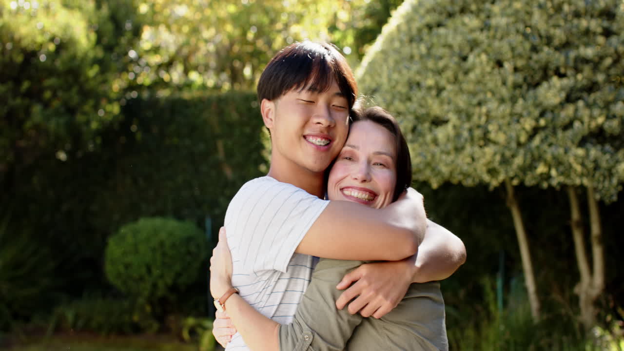 Hugging and smiling, happy family enjoying outdoor time together